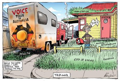 A man stands in an overgrown front yard, after arriving in a car towing a caravan that reads 'Voice Tour of Australia'.